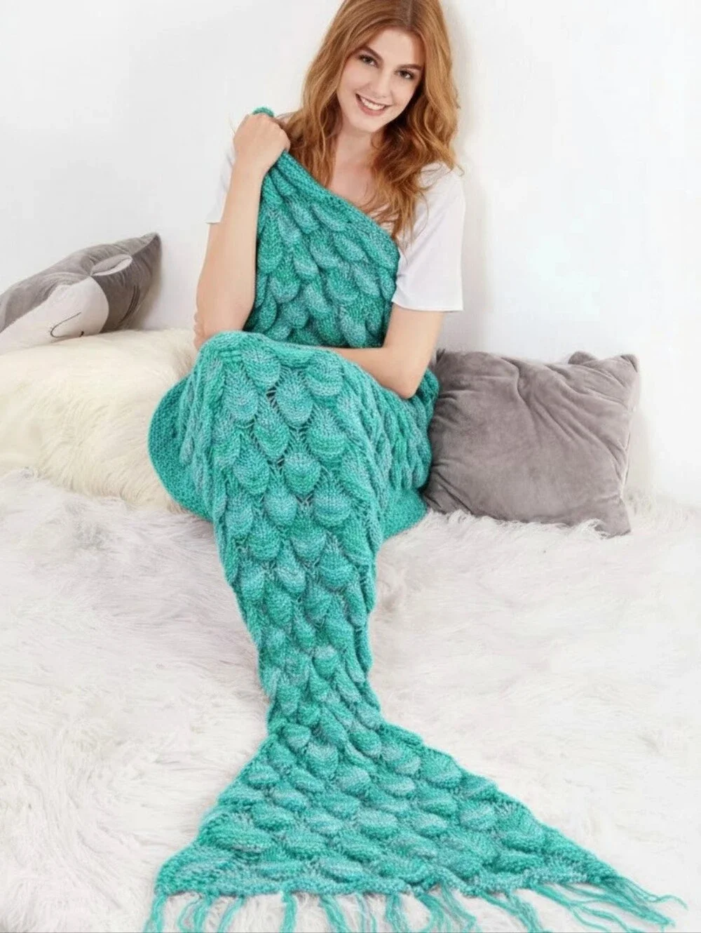 knit teal seafoam mermaid tail blanket with scales and fringe tail